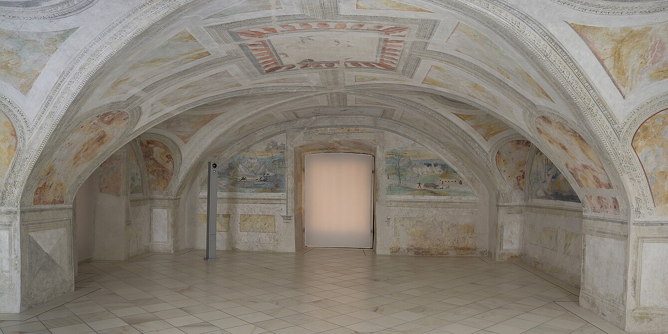 
Photograph of a room with a vaulted ceiling. On the ceiling there are frescoes painted in bright colors.