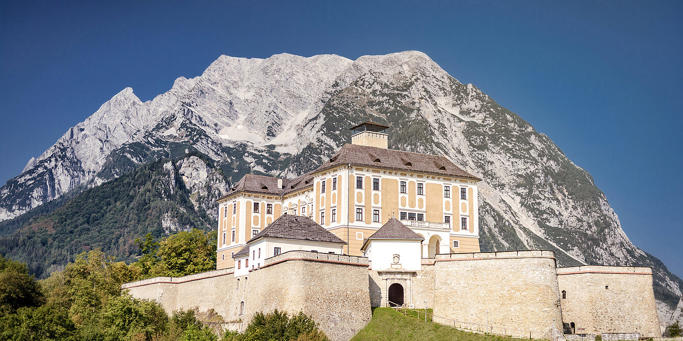 Photography of Trautenfels Castle in front of Mount Grimming
