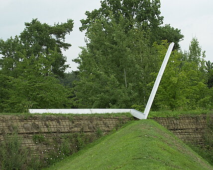The sculpture "Now" is a double-angled steel rail at the top of a slope. It represents a timeline or a diagram of personal development and points to changes in direction.